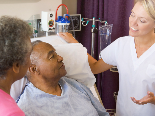 a doctor speaking to patient and his wife