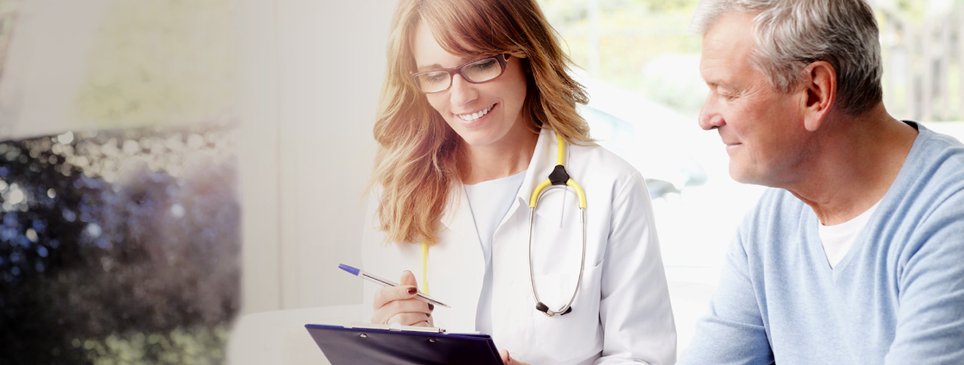 a doctor showing a man something on a paper