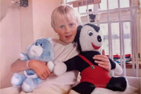 young boy posing with his teddies