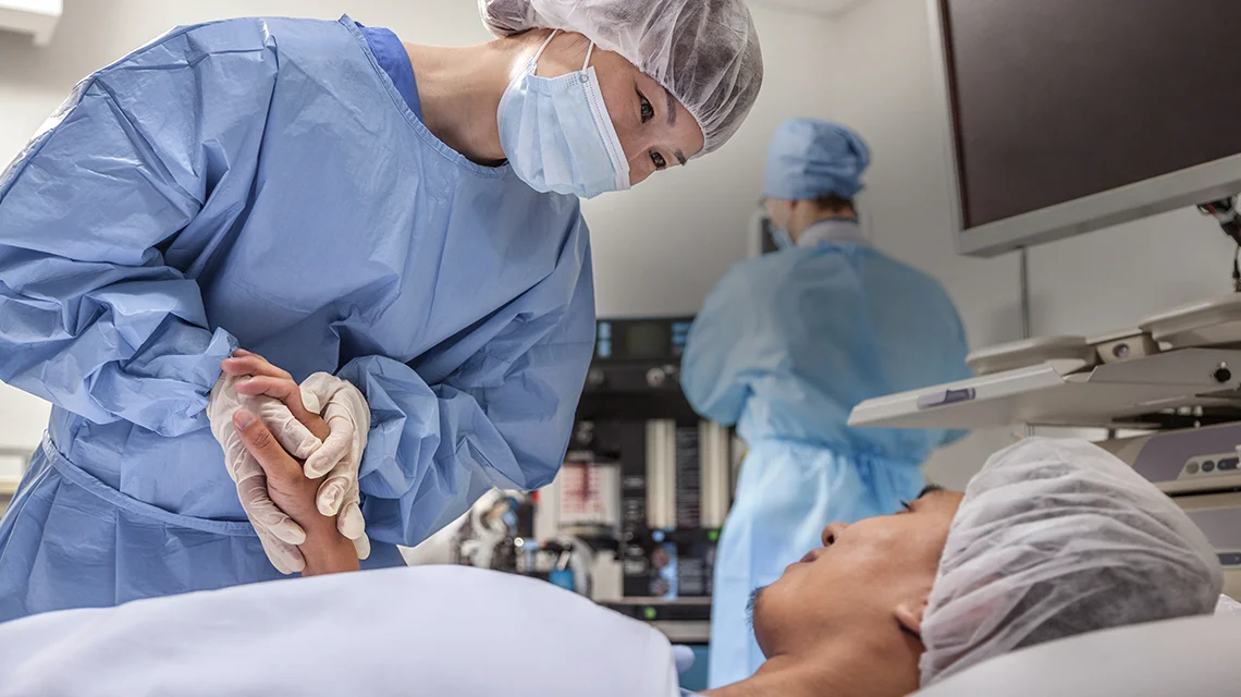 a surgeon attending to a patient