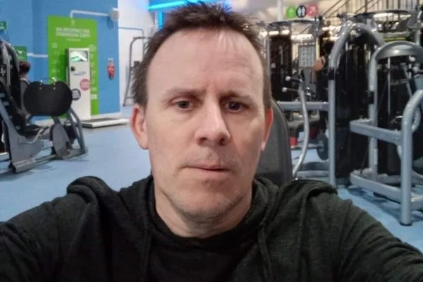 man living with a stoma at a gym
