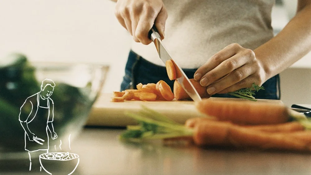 a person cutting a sandwich