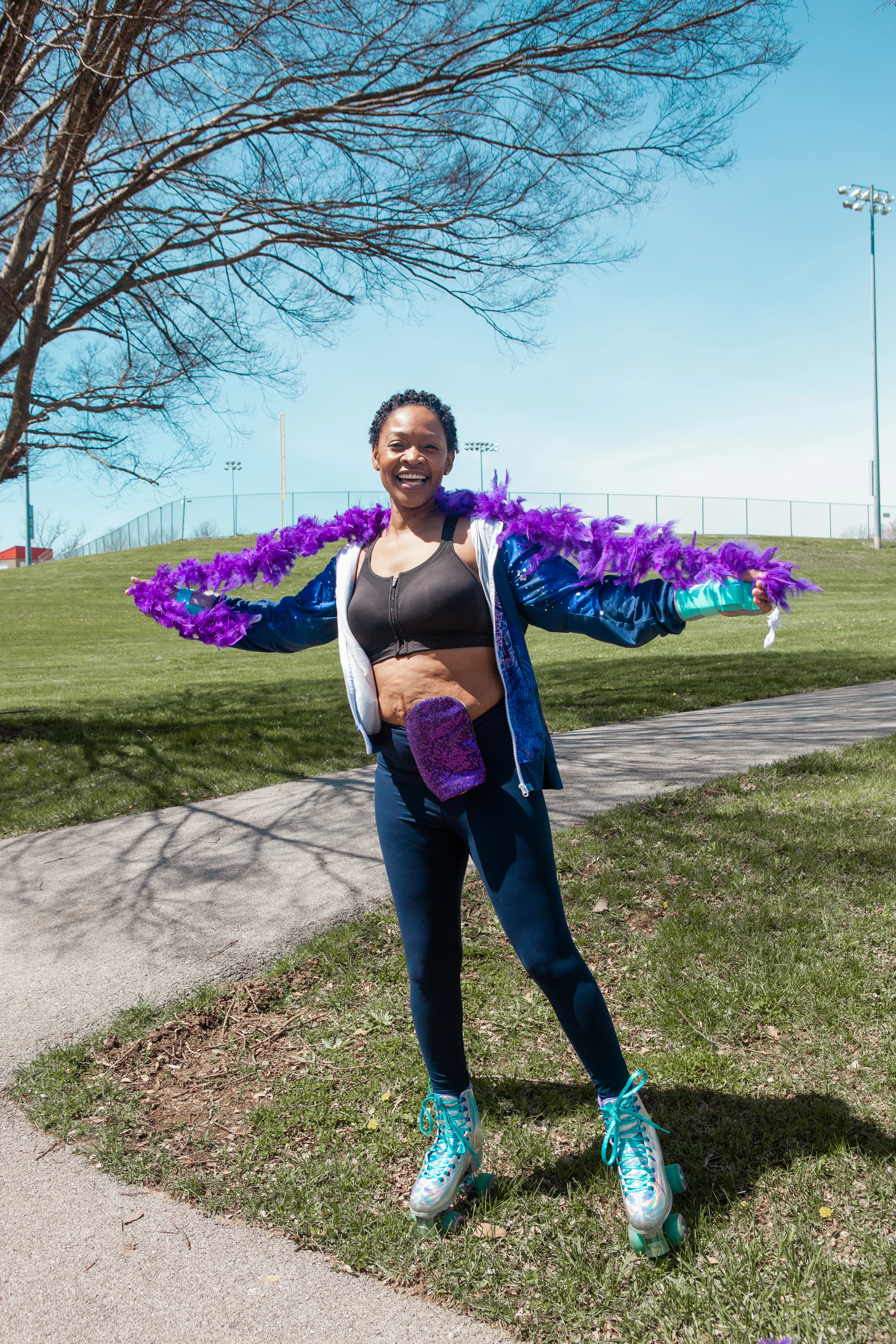 a woman on a path with a feather boa