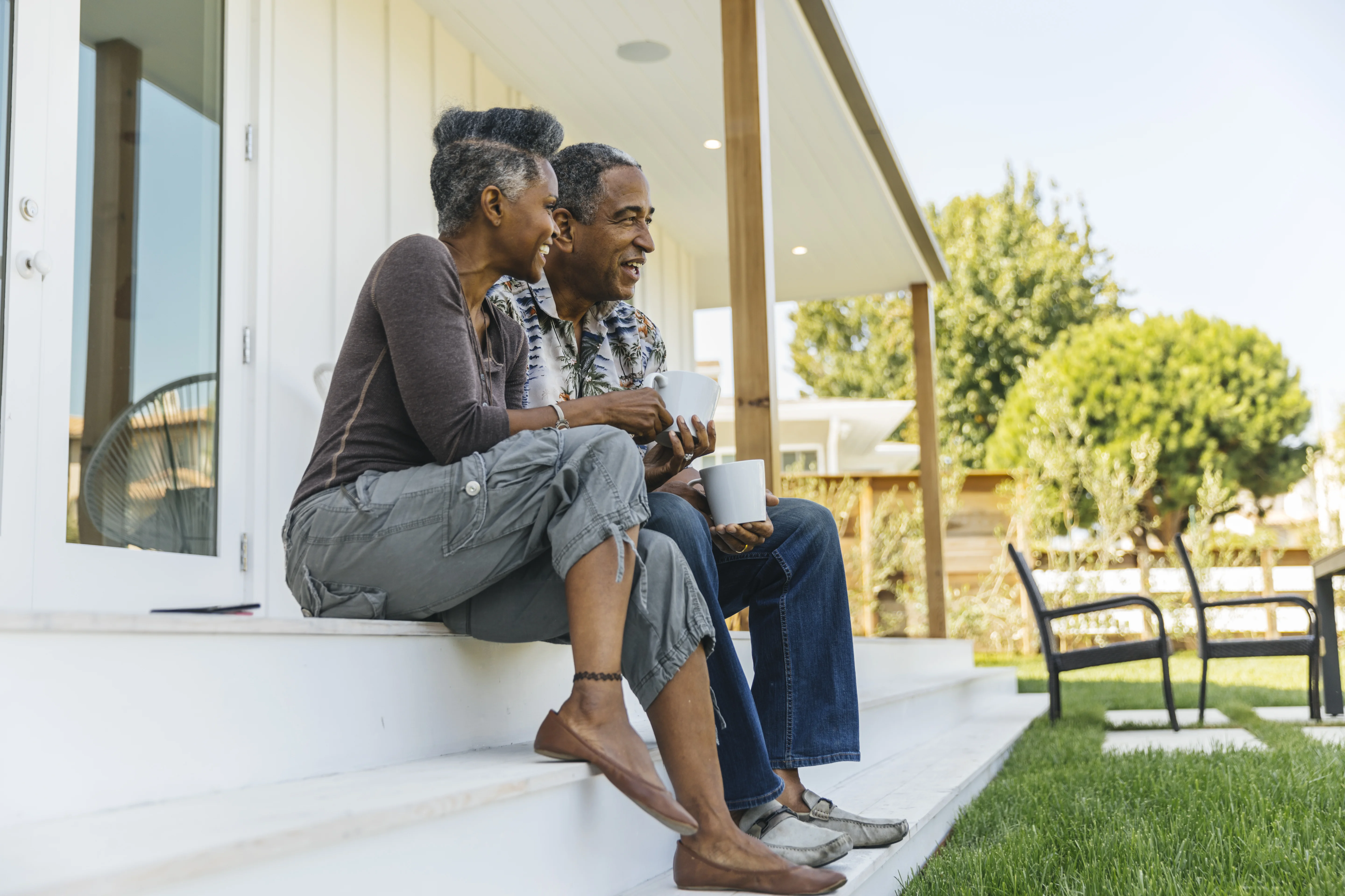 a man and a woman sitting on a porch