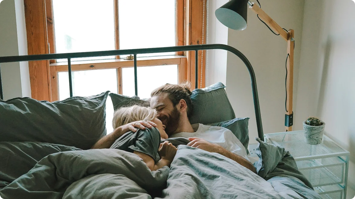a man and a woman lying on a bed