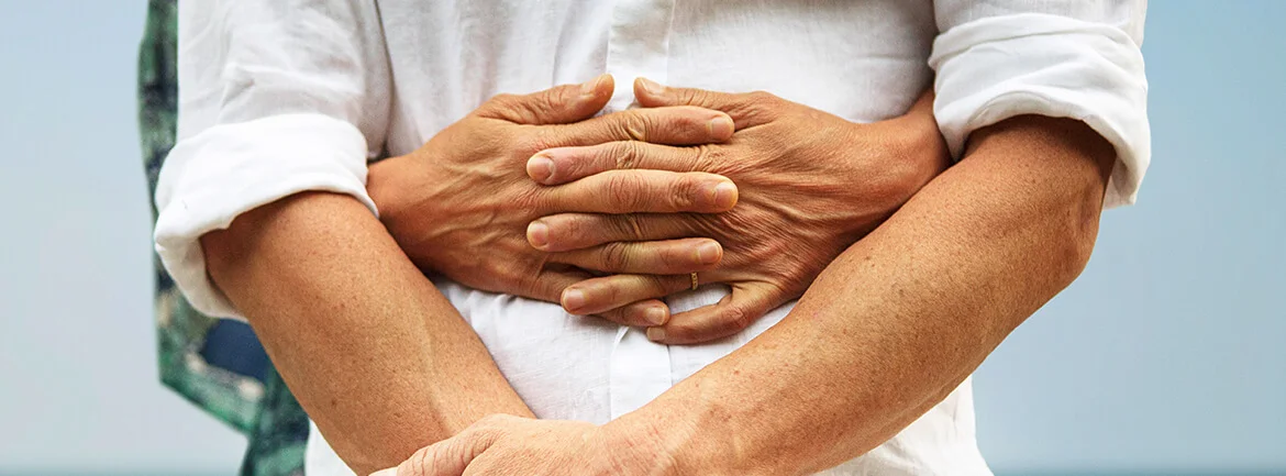 a close-up of a man holding his arms around another person